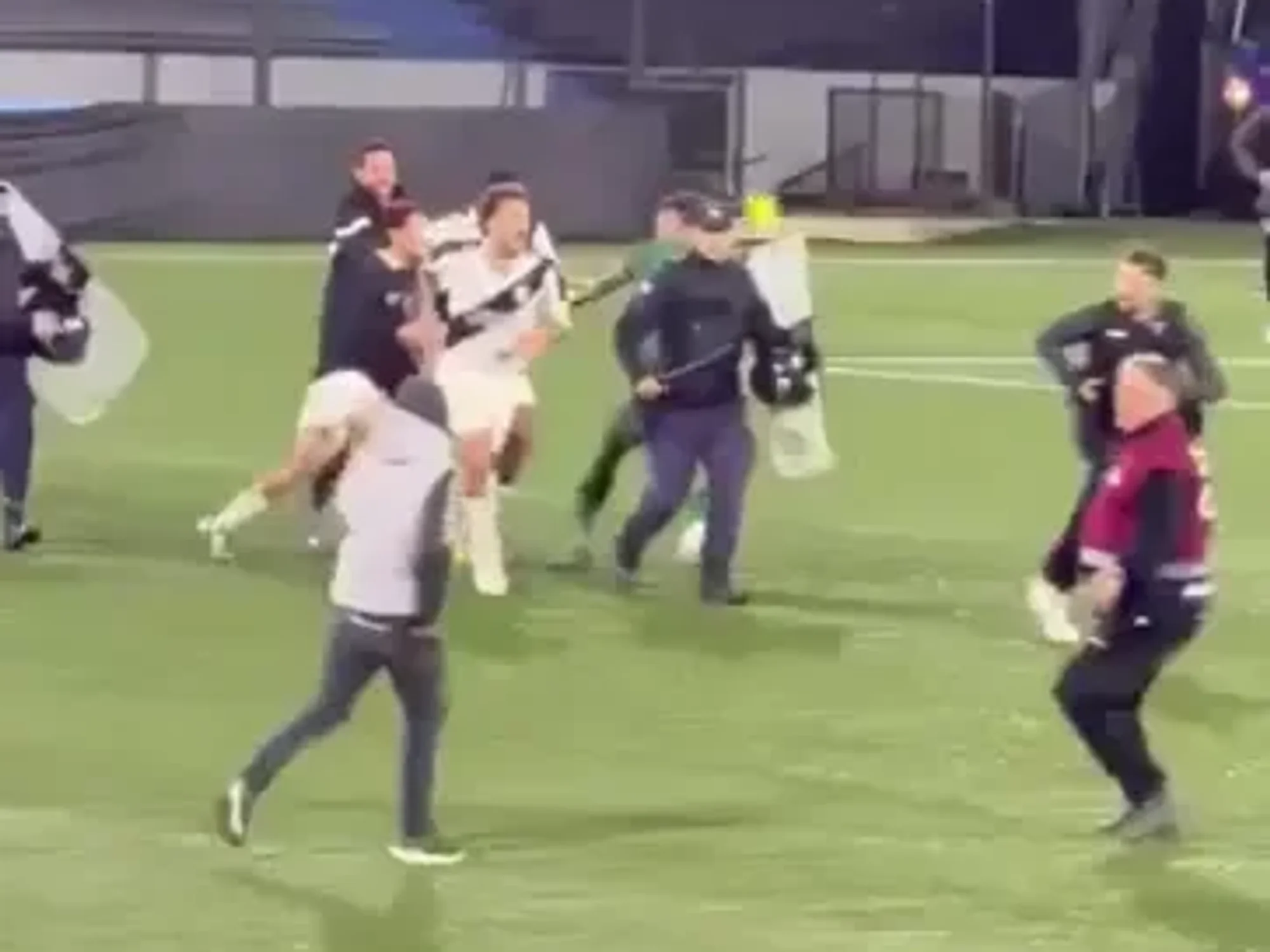 A football match in Uruguay descended into extraordinary scenes after a goalkeeper raced towards a pitch invader who appeared to attack players from his own team
