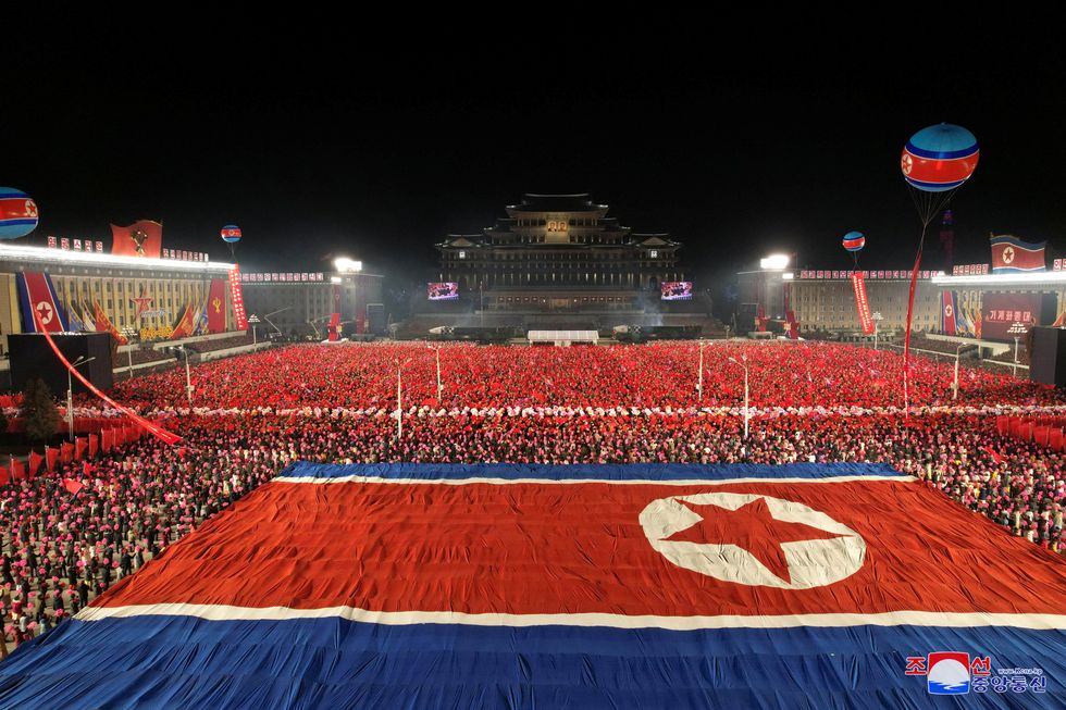 A giant North Korean national flag is displayed during a military parade to mark the 75th founding anniversary of North Korea's army, at Kim Il Sung Square in Pyongyang, North Korea February 8, 2023, in this photo released by North Korea's Korean Central News Agency (KCNA). KCNA via REUTERS ATTENTION EDITORS - THIS IMAGE WAS PROVIDED BY A THIRD PARTY. REUTERS IS UNABLE TO INDEPENDENTLY VERIFY THIS IMAGE. NO THIRD PARTY SALES. SOUTH KOREA OUT. NO COMMERCIAL OR EDITORIAL SALES IN SOUTH KOREA.