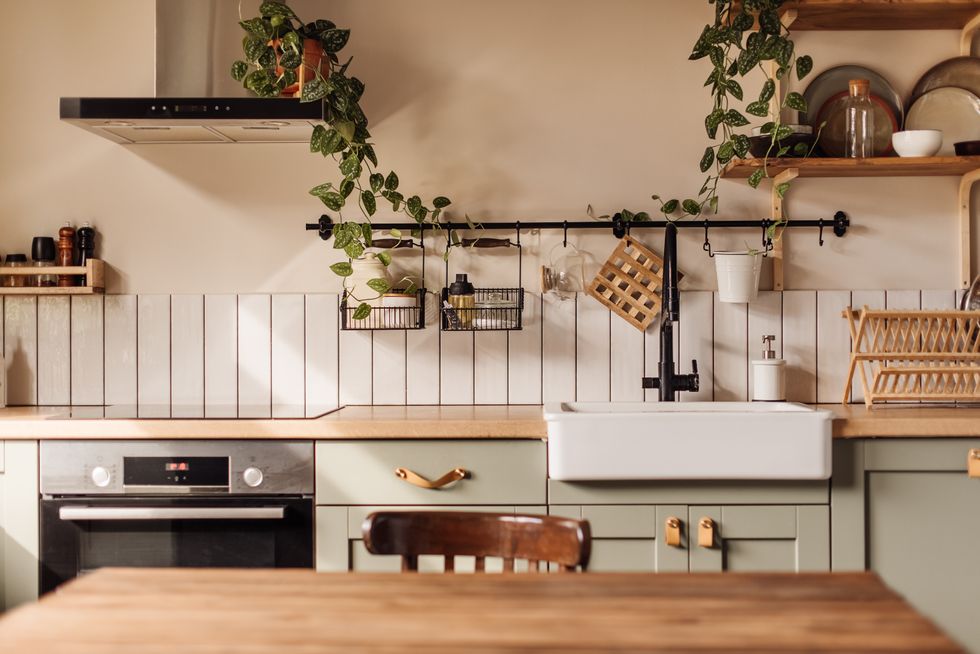 A kitchen with light green cabinets