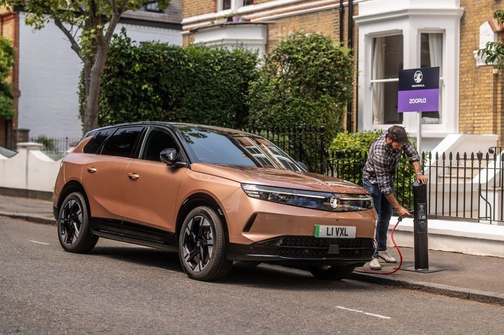 A man charging a Vauxhall EV at a Zoopla charger