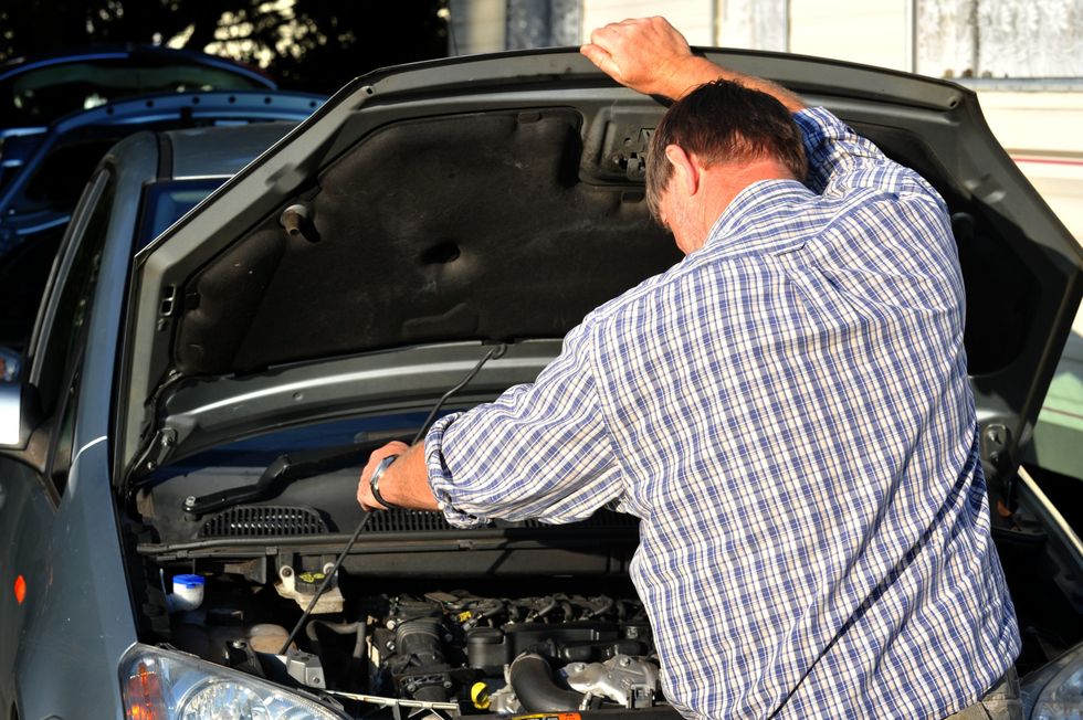 A man checking his engine