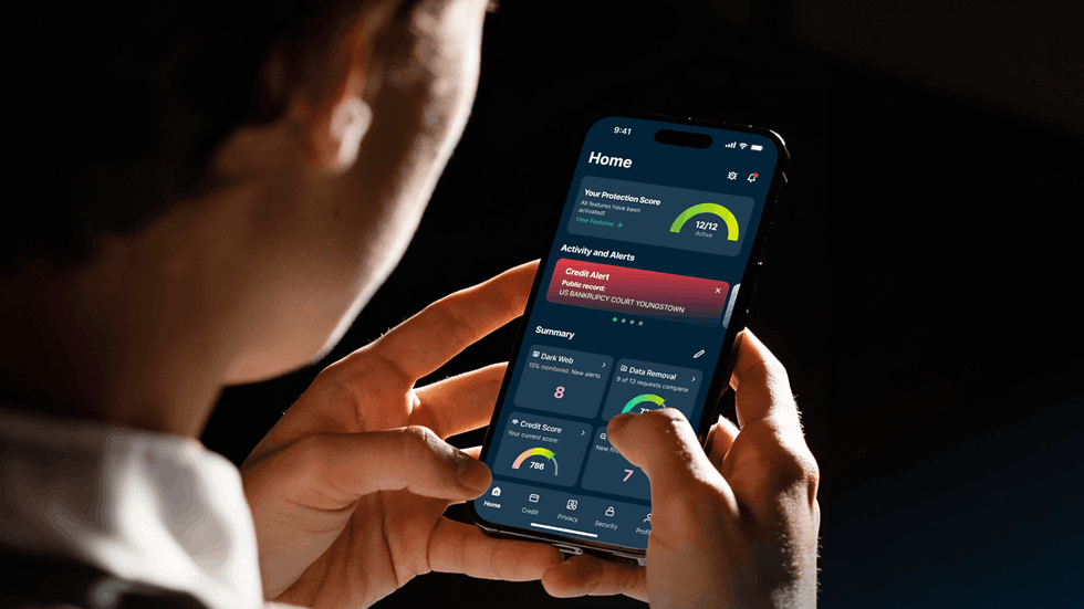 a man holds an iPhone in both hands with ExpressVPN shown on-screen 