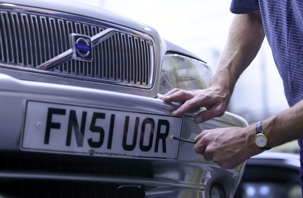 A man screwing on a number plate