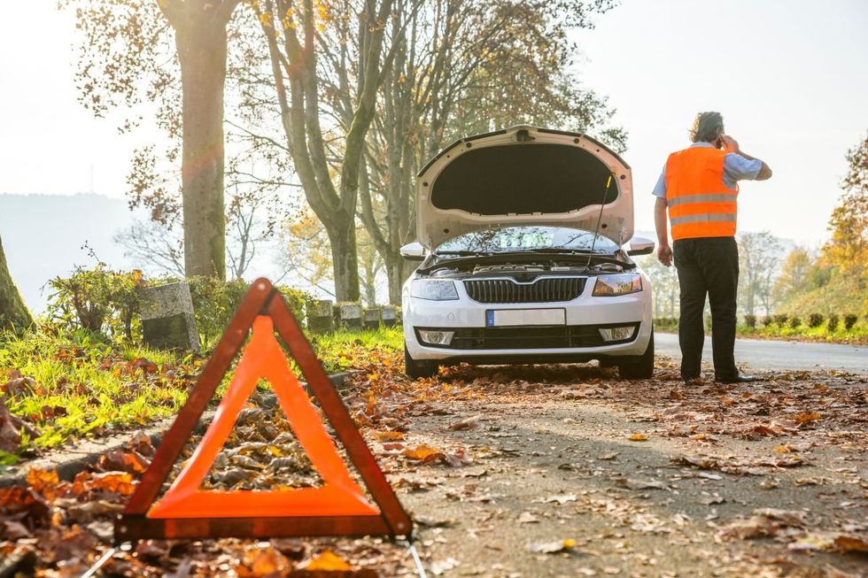 A man waiting for his vehicle to be repaired after breaking down