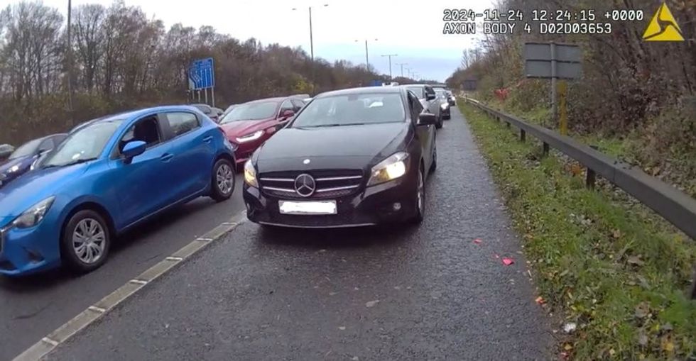 A Mercedes-Benz van on the hard shoulder of the motorway