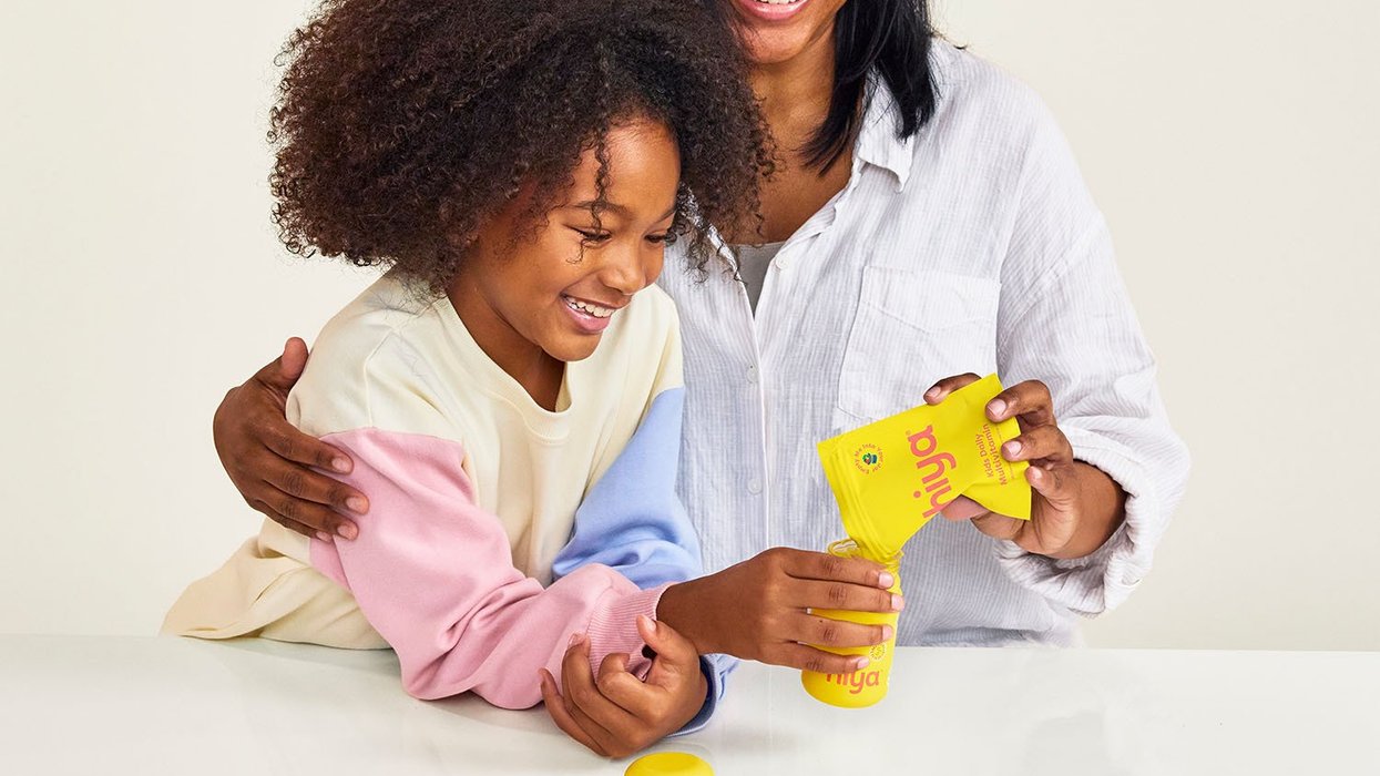 A parent and child holding the Hiya supplements
