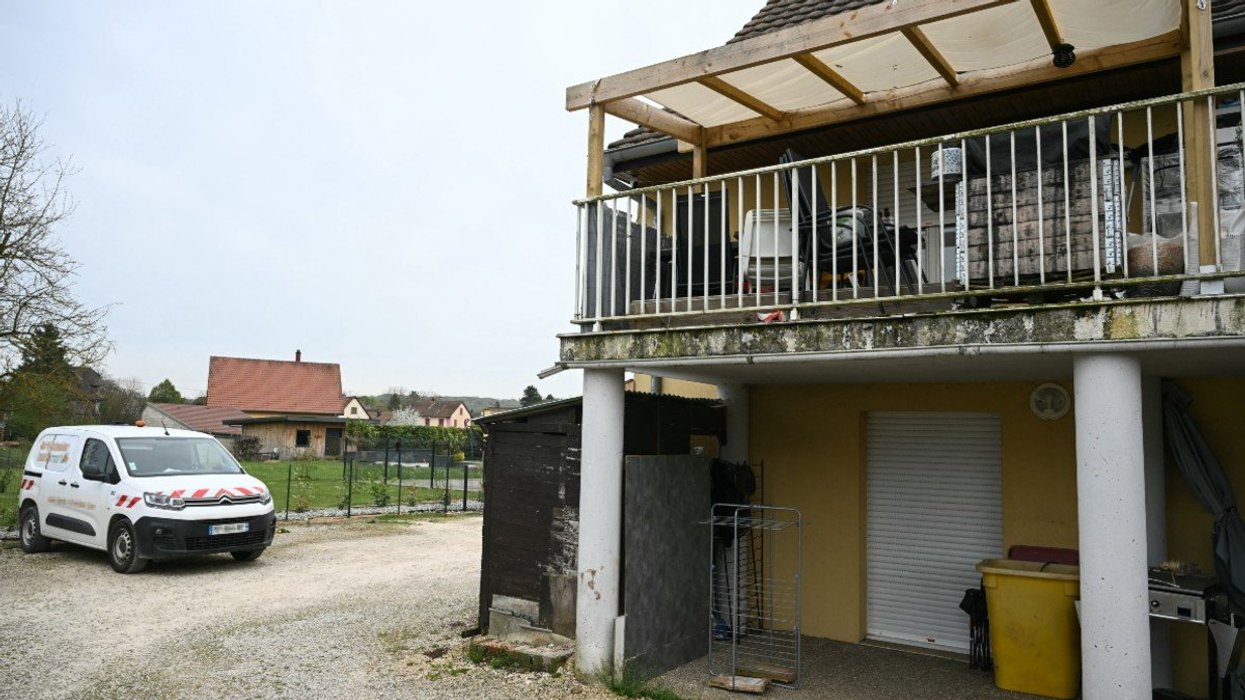 A photo shows a residential building, with the involved suspects' terrace at the first level (R), and parking area at the location where a boy was discovered naked and malnourished on a pile of rubbish in a van where he had been kept locked up, in Hagenbach, eastern France, on April 10, 2026