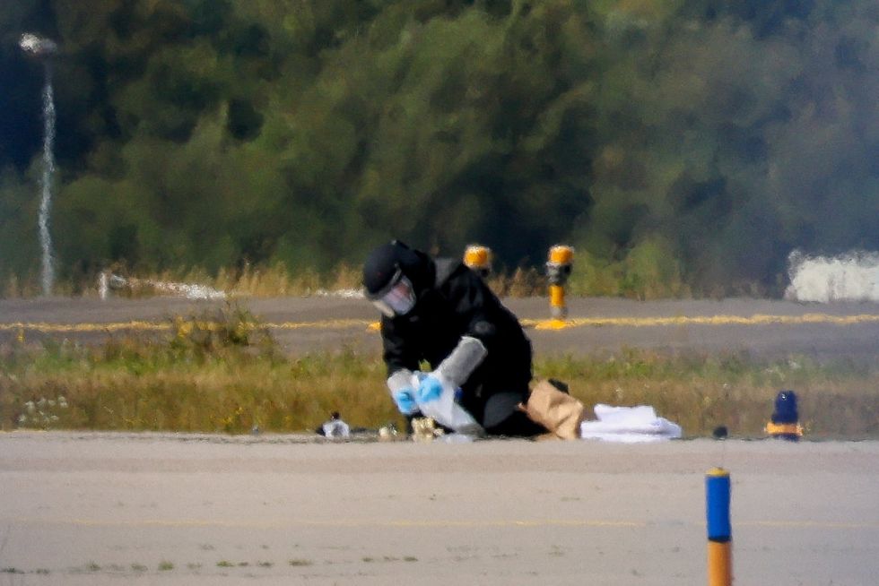 A police officer in protective clothing on the runway at Leipzig/Halle Airport on August 5 after a drone was found on the runway the day before