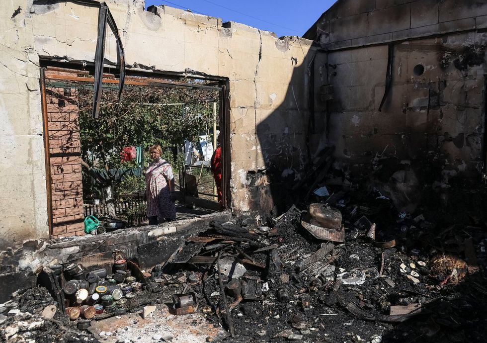 A resident looks at a destroyed private house hit during a Russian drone strike, amid Russia's attack on Ukraine, in Odesa