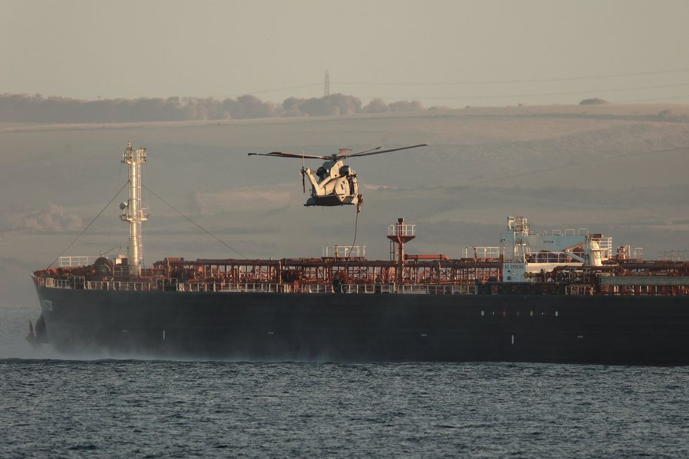 A Royal Marine helicopter hovers over the Smyrtos