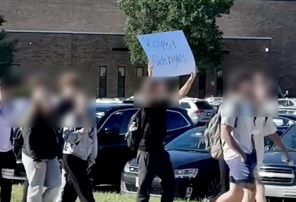 A separate image of a placard being held at the protest