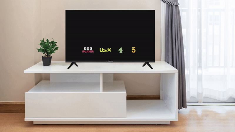 a television on a stand displaying the freely logo on-screen, known as the Freemoji