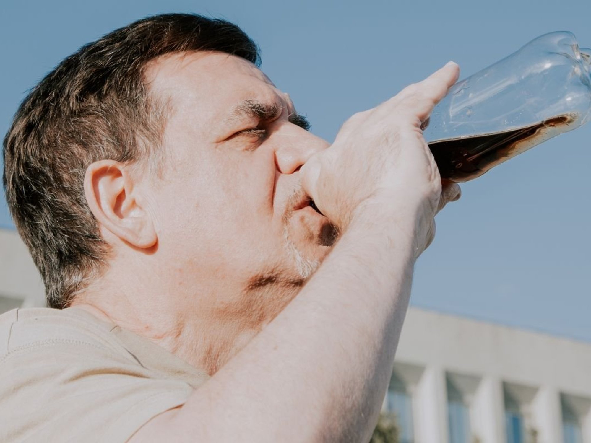 ADULT DRINKING COKE