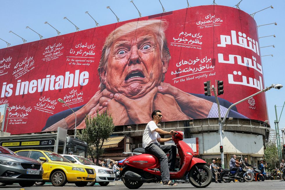 An Iranian propaganda billboard showing hands throttling Donald Trump