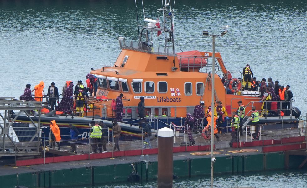 An RNLI lifeboat with people thought to be migrants on board