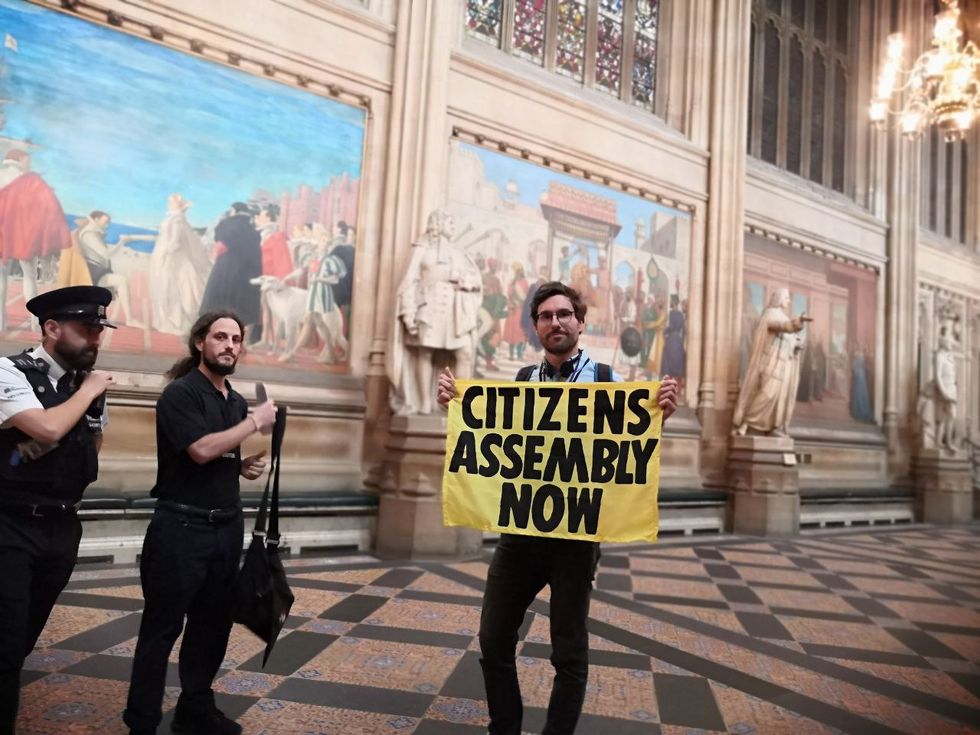 An XR protester within Parliament.