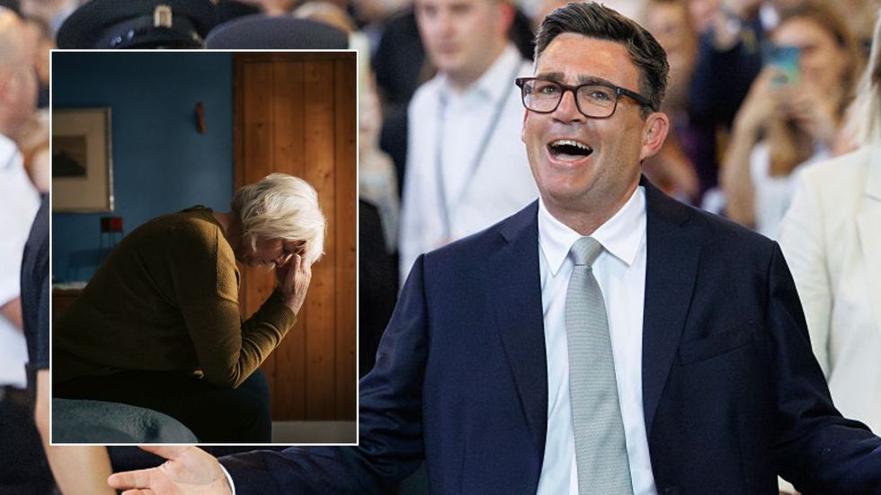 Andy Burnham and older woman looking worried