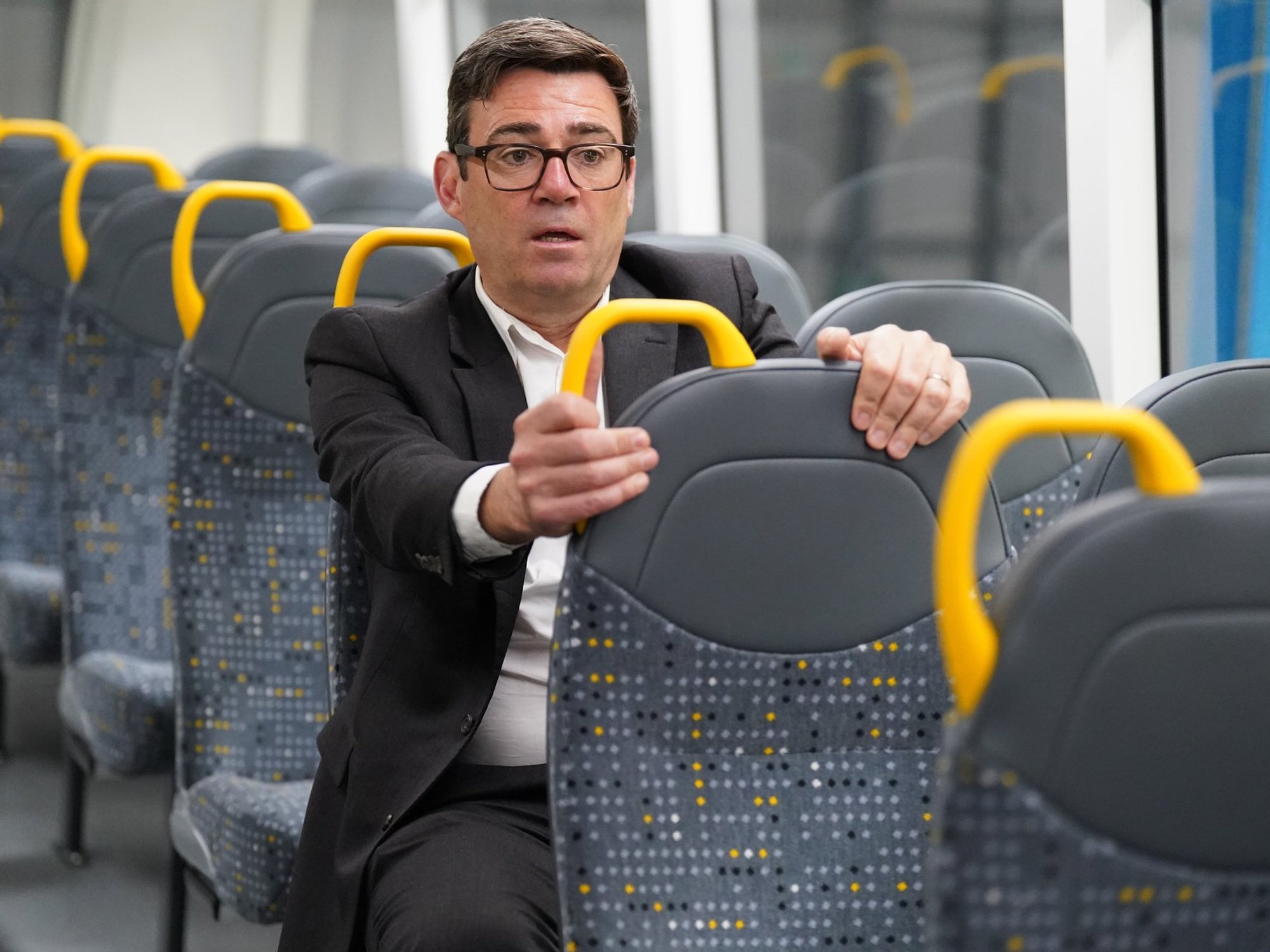 Andy Burnham sitting on a bus