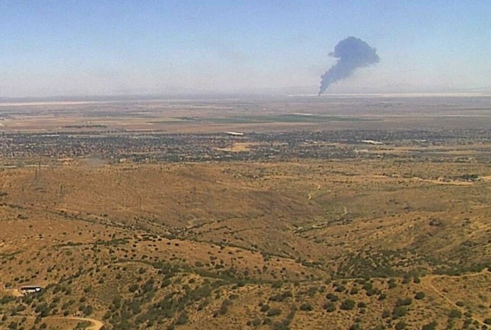Black smoke plume in hills of California
