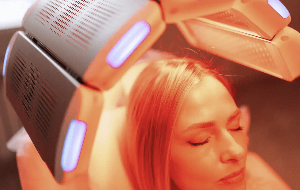 Blonde woman under a red light mechanism