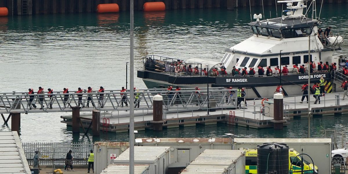 Hundreds of illegal migrants brave stormy seas as mega-dinghy among boats making Channel crossing
