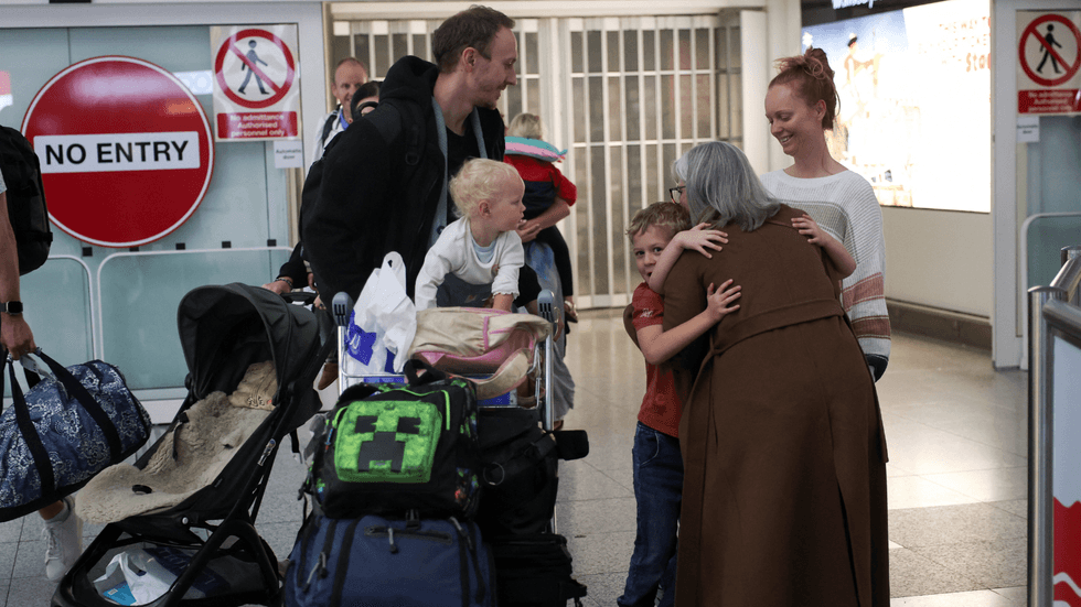 British family at Stansted Airport after evacuation flight