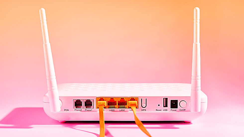 broadband router pictured with two ethernet cables plugged in