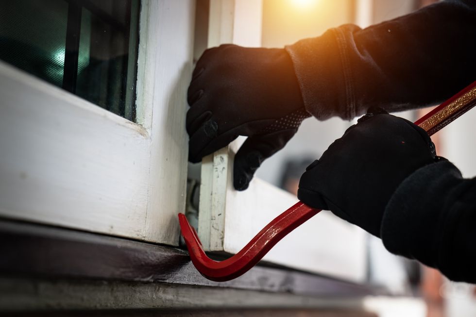 Burglar breaking in to someone's home