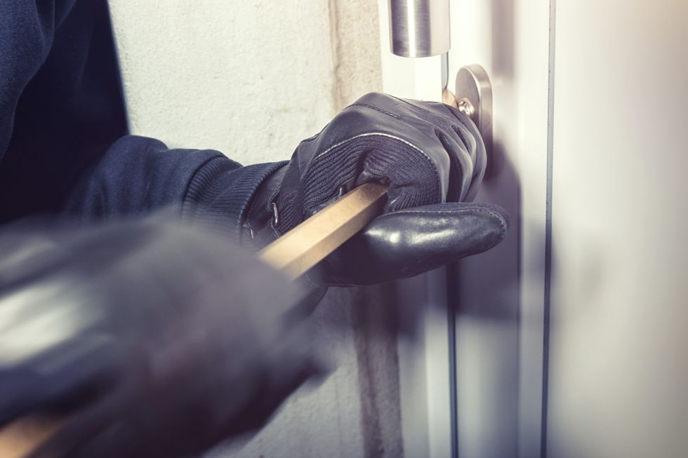 Burglar trying to break into a home
