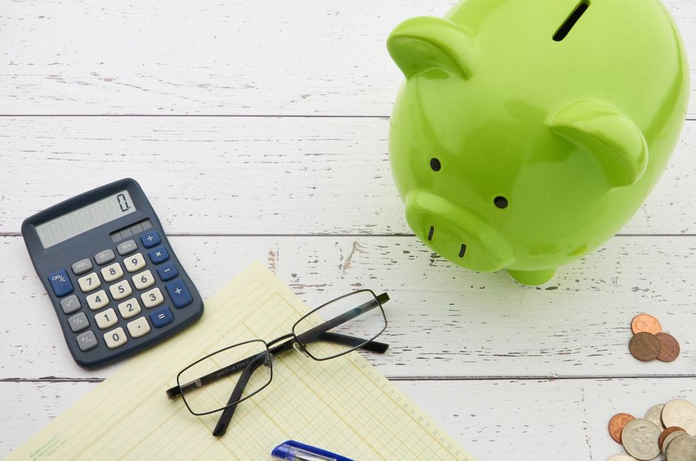 Calculator, paperwork and a piggybank