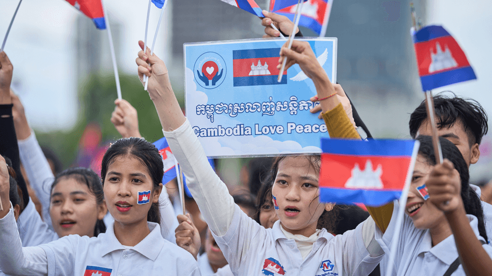 Cambodians hold flags on a peace march in capital Phnom Penh