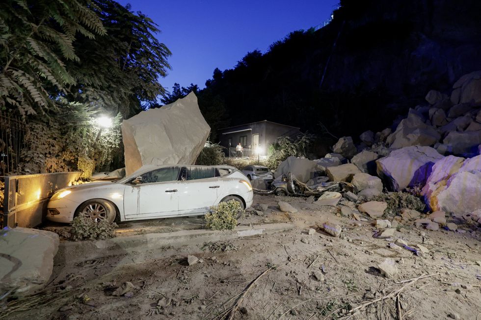 Car crushed by fallen boulder