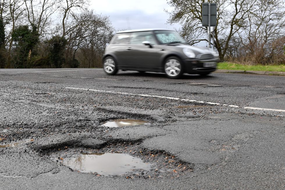 Car driving near a pothole