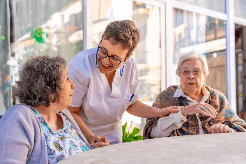 Care home nurse with two patients
