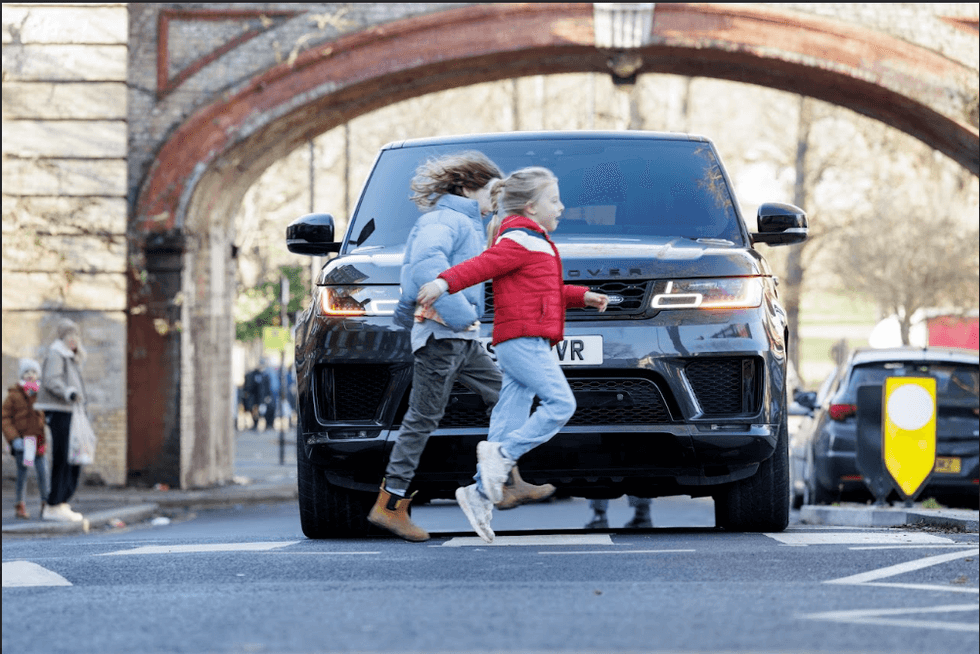 Children running in front of car