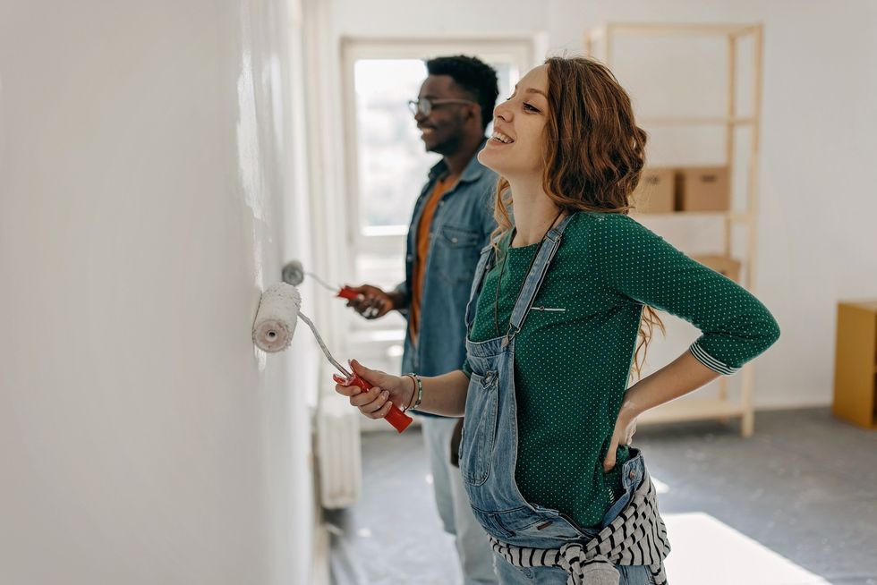 Couple painting their walls grey
