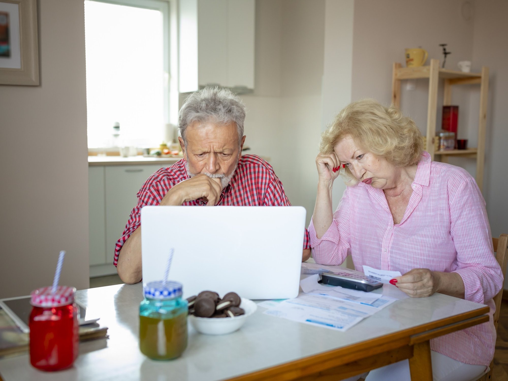 Couple worried looking at bills