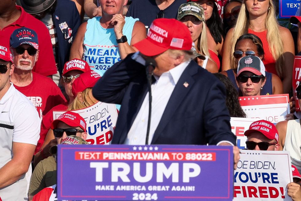 Donald Trump clutching his ear