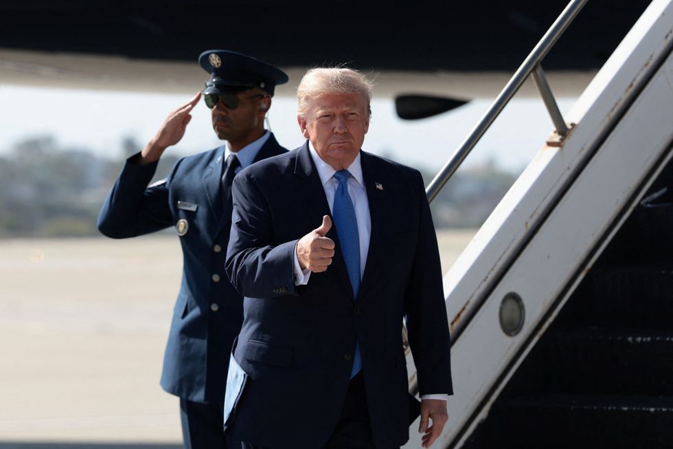 Donald Trump doing a thumbs up as he disembarks Air Force One in California
