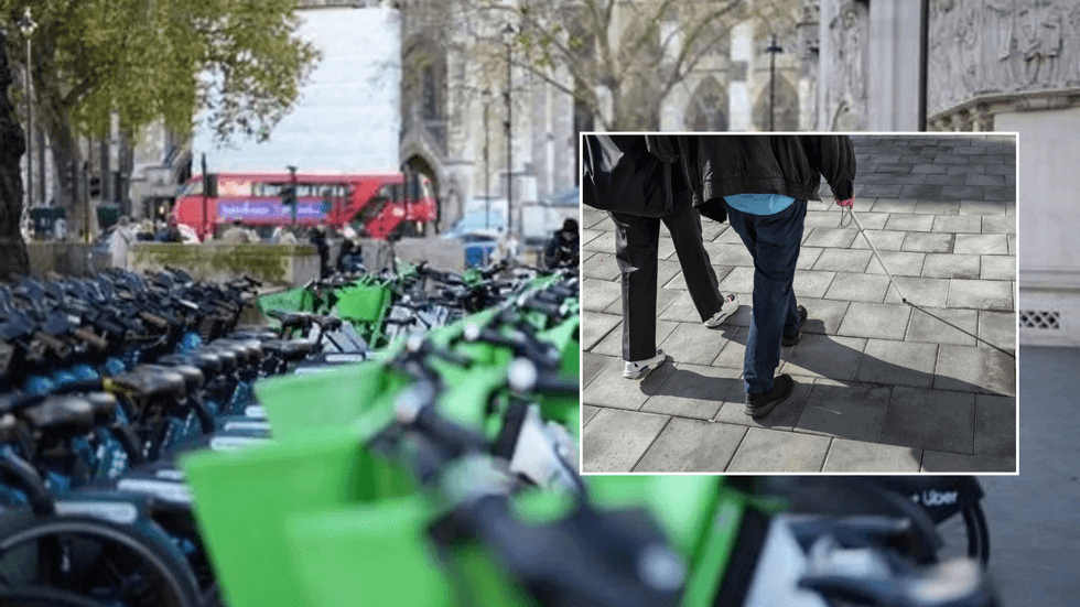 E-bikes parked on pavement and visually impared person on roads