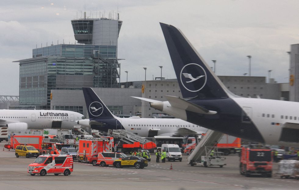 Emergency crews around a Lufthansa-operated Boeing 787 with nose collapsed