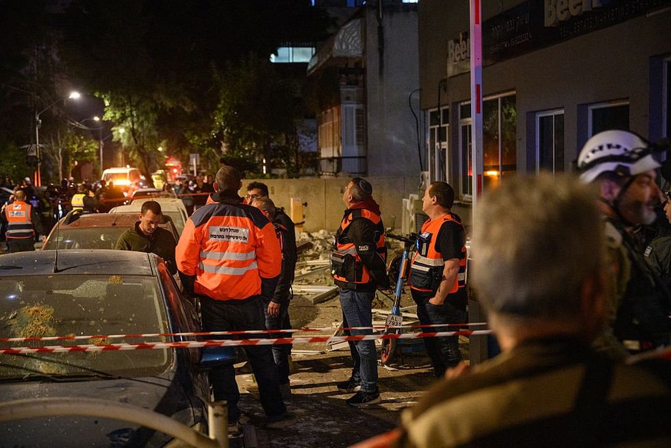Emergency workers respond to a ballistic missile attack in eastern Tel Aviv