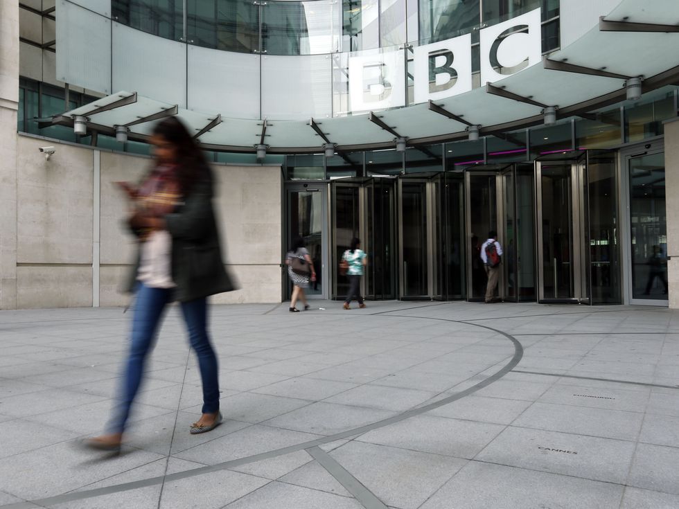 Employees arrive at Broadcasting House in London