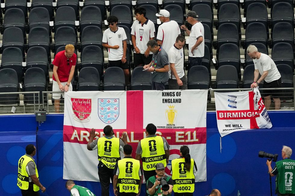 England fans remove St George's flags during Wednesday night's World Cup match with Croatia