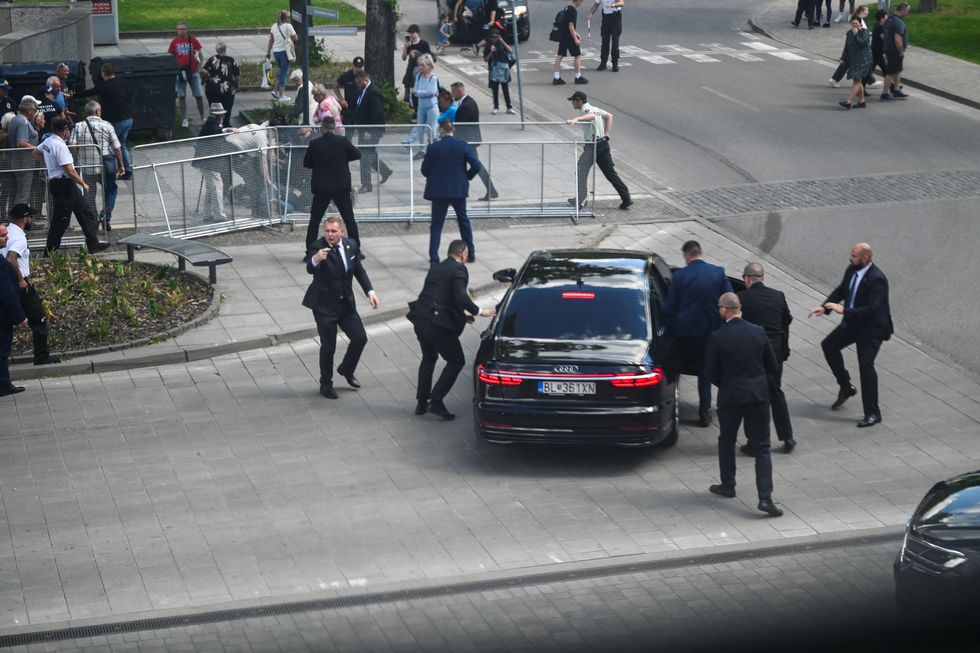 Fico being moved into a car