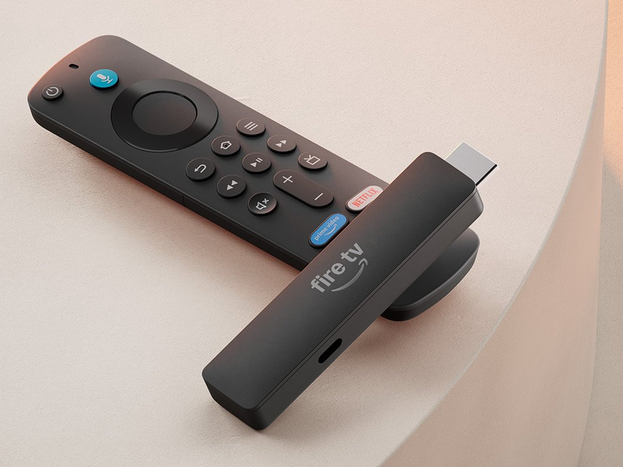fire tv stick with remote lying next to it