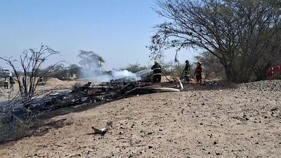 Firefighters extinguish Peru plane crash wreckage