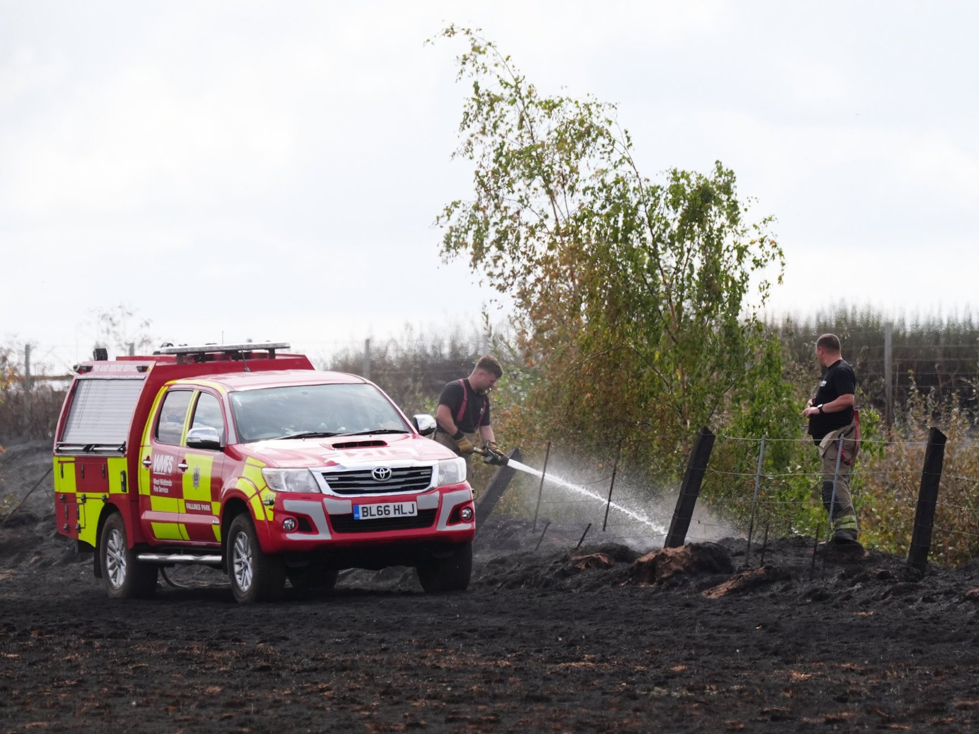 Firemen putting out wildfires in Britain