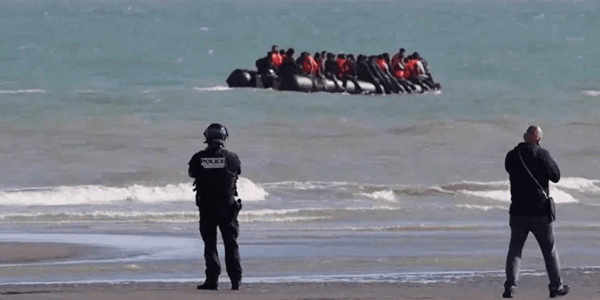 French police armed with riot shields and batons stand watch and do NOTHING as boat filled with migrants leaves for Britain