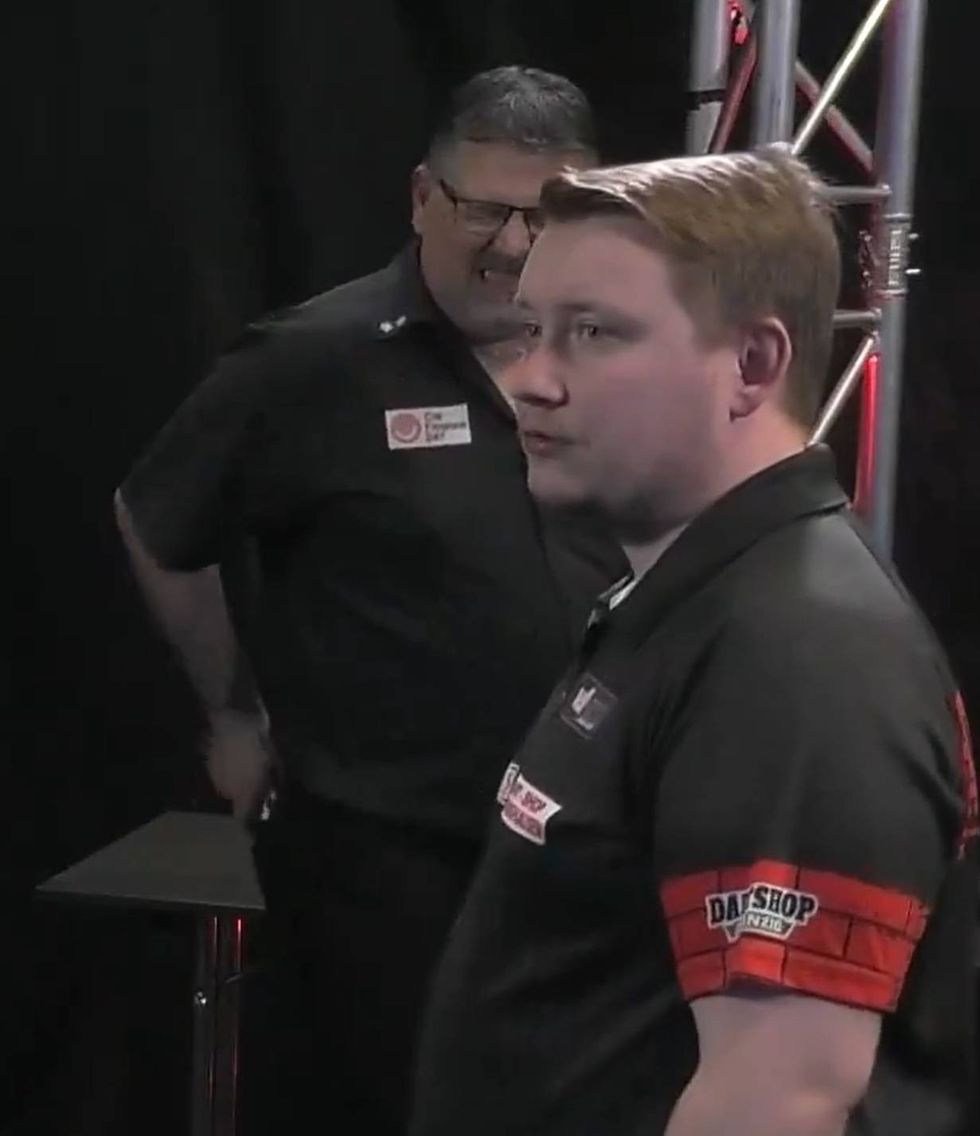 Gary Anderson grimaced in pain at one point